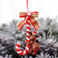 Christmas Santa Claus ornament hanging on tree with festive background