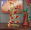 Red gold iron mini Christmas tree on desk with Bible in background