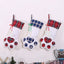 Dog paw Christmas stocking hanging by fireplace for holiday display