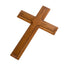 Apricot pine cross pendant with smooth finish hanging against a light background