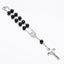 Rosary bracelet with dripping cross connector on neutral background