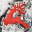 Gold-finish Christmas reindeer ornament hanging on tree branch