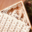 DIY wooden Christmas advent calendar with carved compartments arranged on festive table