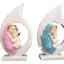 Hand painted resin ornament showing Mary tenderly holding baby Jesus in soft pink tones