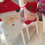 Red and green Christmas themed chair cover with holiday pattern for festive dining