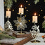 Romantic wrought iron Christmas candlestick with snowflake design on rustic surface