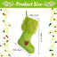 Green plush Christmas stocking ornament hanging on a tree with festive holiday decor