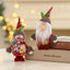 A standing doll representing an old man crafted from festive foam fabric, displayed as a Christmas ornament