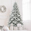 Fully decorated PVC Christmas tree with festive ornaments and warm lighting in a home setting