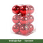 Red electroplated Christmas ornament balls hanging on a tree branch in festive setting
