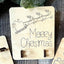 Wooden Christmas tree money clip rack for holding bills on a festive table