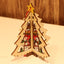 Christmas wooden star ornament with five points resting on green branches