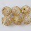 Gold-tone scaly Christmas ball ornament displayed prominently for faith-based holiday gifting