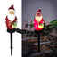 Christmas solar yard lamp glowing warmly in evening setting