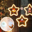 Five-pointed star LED pendant decoration glowing softly against a festive backdrop
