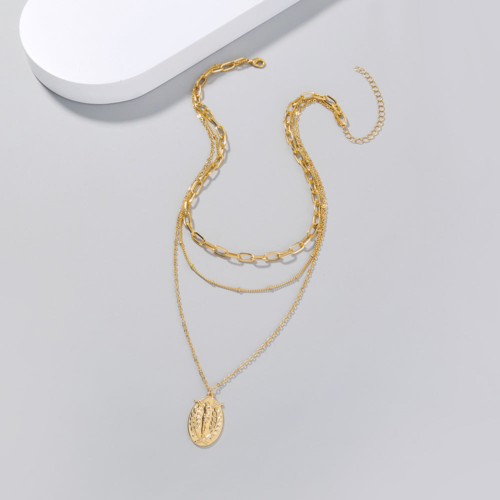 Gold-tone alloy pendant necklace featuring geometric Jesus symbol