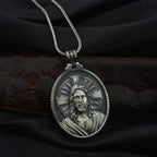 Close-up of tin cross pendant with religious detailing