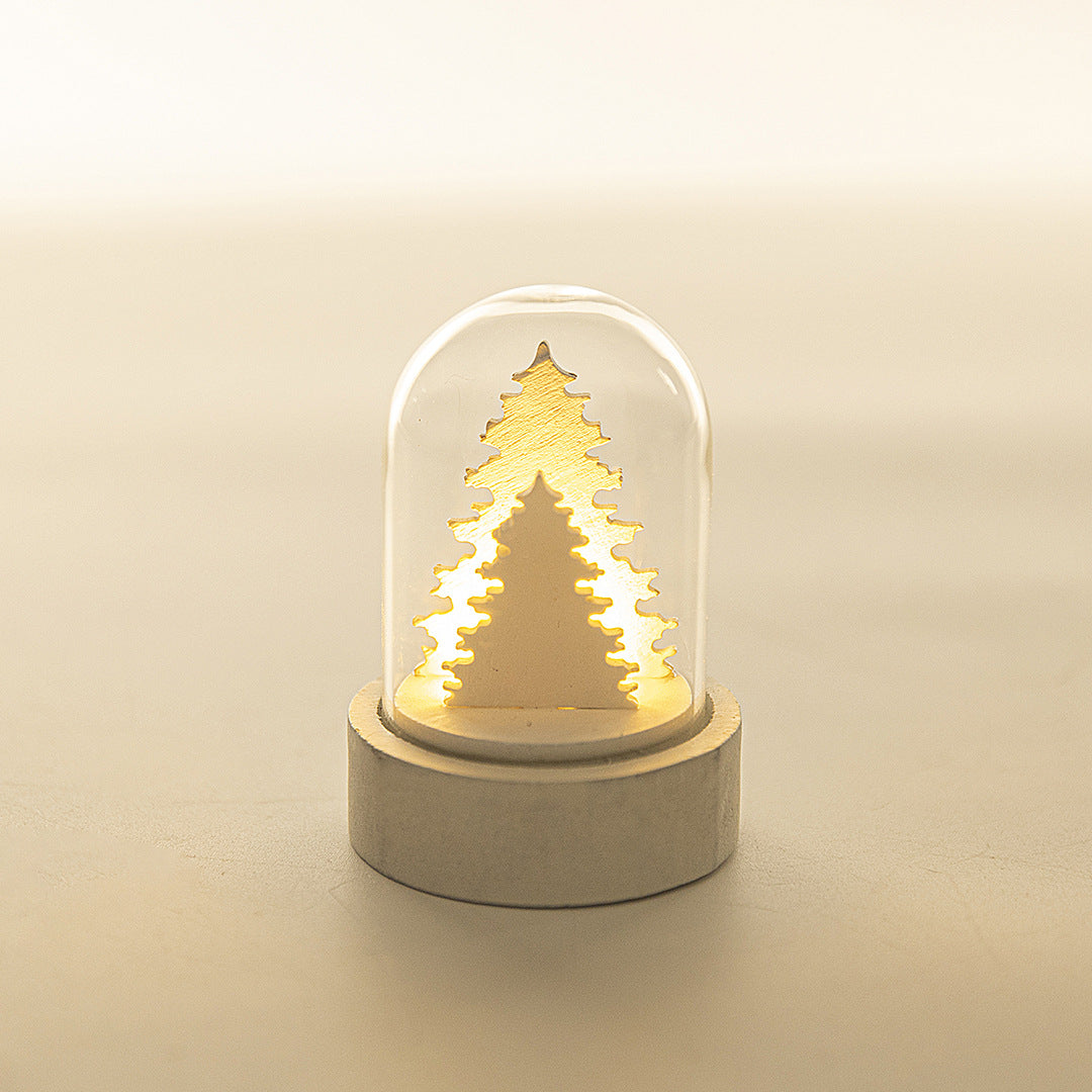 Close-up of wooden cottage Christmas ornament with cozy light effect