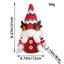 Festive deer doll with pointed red hat standing in cozy Christmas setting