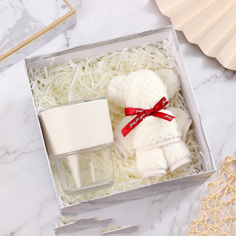 White ceramic gift set with green accents on rustic surface - faith