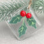 Glass Christmas tree pendant with faceted design suspended on branch