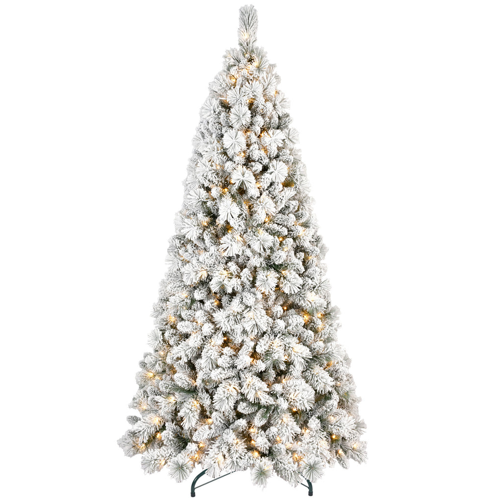 Small flocked Christmas tree on table with warm white LED lighting