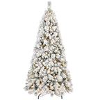 Small flocked Christmas tree on table with warm white LED lighting