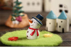 Handmade Christmas tree resin figurine with carved detailing on wooden surface