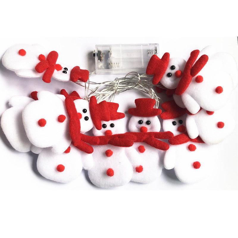 Soft plush snowman figures on a warm white LED string light strand