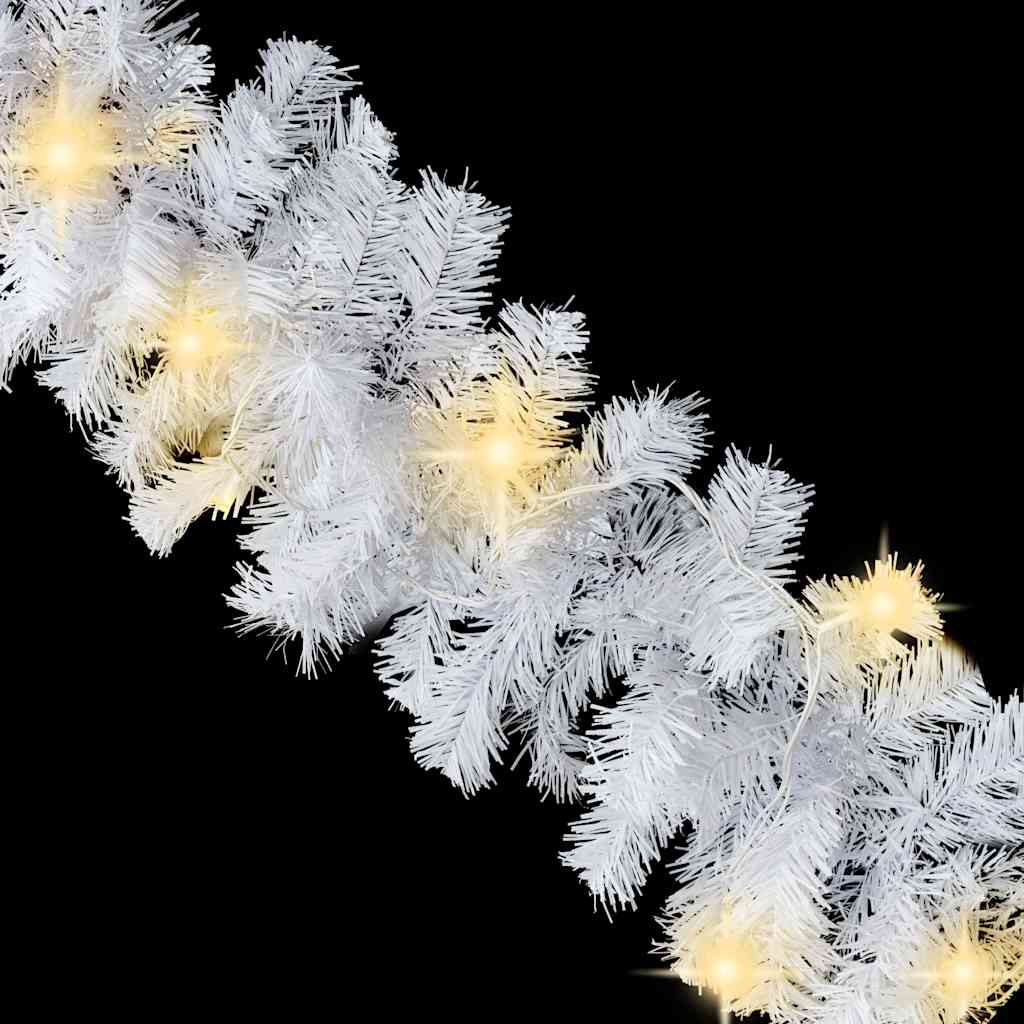 Close-up of glowing LED lights on white Christmas garland