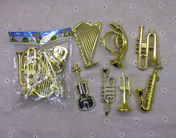 Assorted small musical instrument Christmas tree decorations arranged in festive holiday setting
