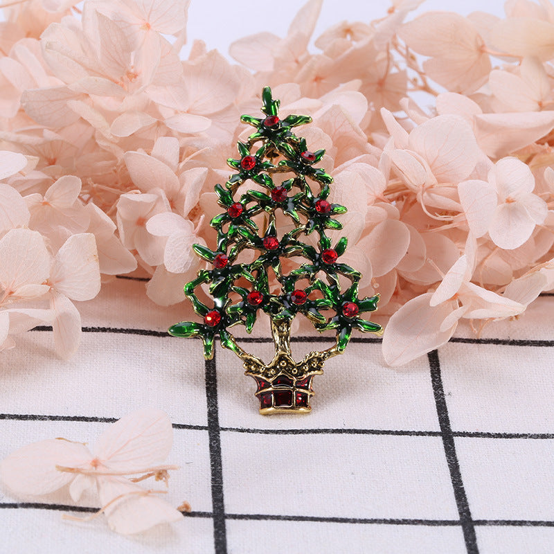 Green alloy brooch showcasing festive Christmas tree motif