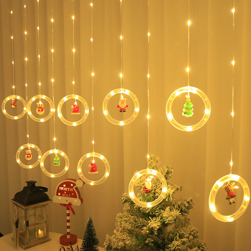 Warm glowing Christmas curtain lights hanging behind curtains in a festive living room