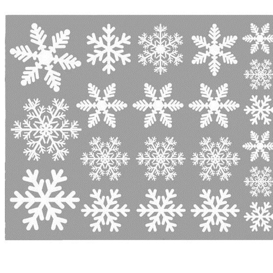 Close-up of delicate white snowflake static stickers for holiday window decoration