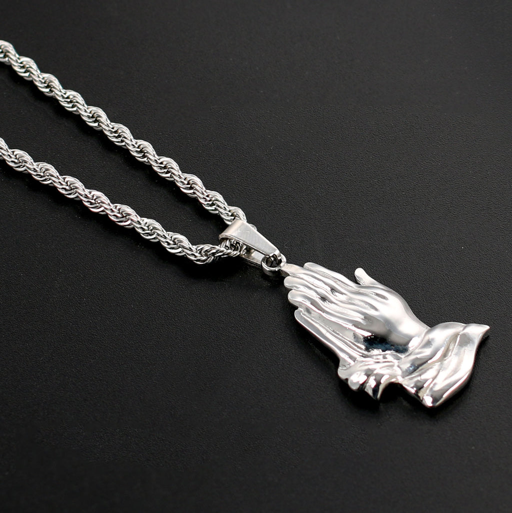 Close-up view of titanium steel praying hands pendant detail