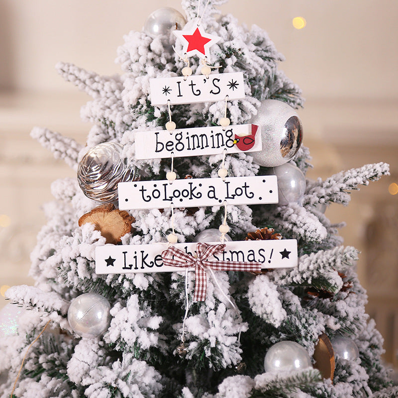 Close-up detail of wooden star ornament with letters spelling Christmas message