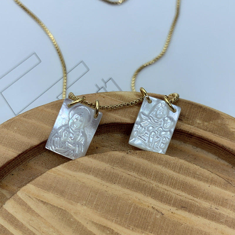 White pendant necklace displayed against soft background
