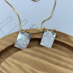 White pendant necklace displayed against soft background