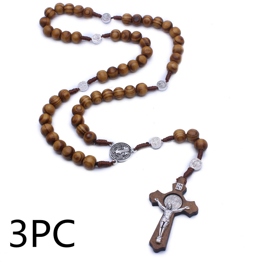 Wooden cross pendant on rosary necklace