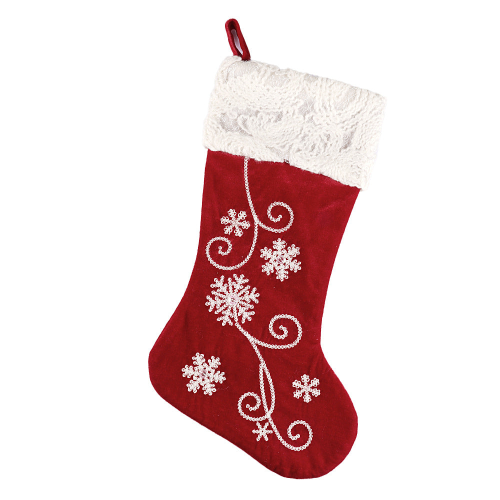 Snowflake embroidered velvet sock pendant displayed as Christmas ornament