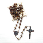 Close up view of imitation agate beads and benedict cross pendant for prayer devotion