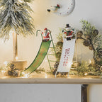 White snowman sliding ornament in rustic wrought iron for holiday decor