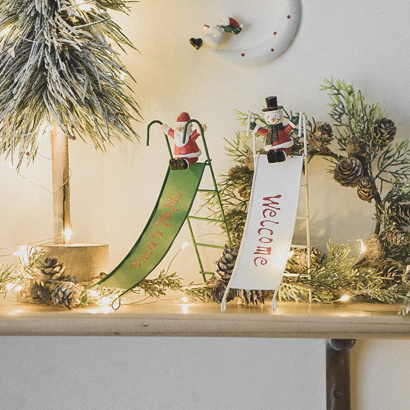 White snowman sliding ornament in rustic wrought iron for holiday decor