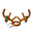 Family playing Christmas ring toss game with antler headband outdoors