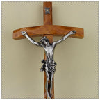 Decorative wooden cross wall piece with metal sacred figure