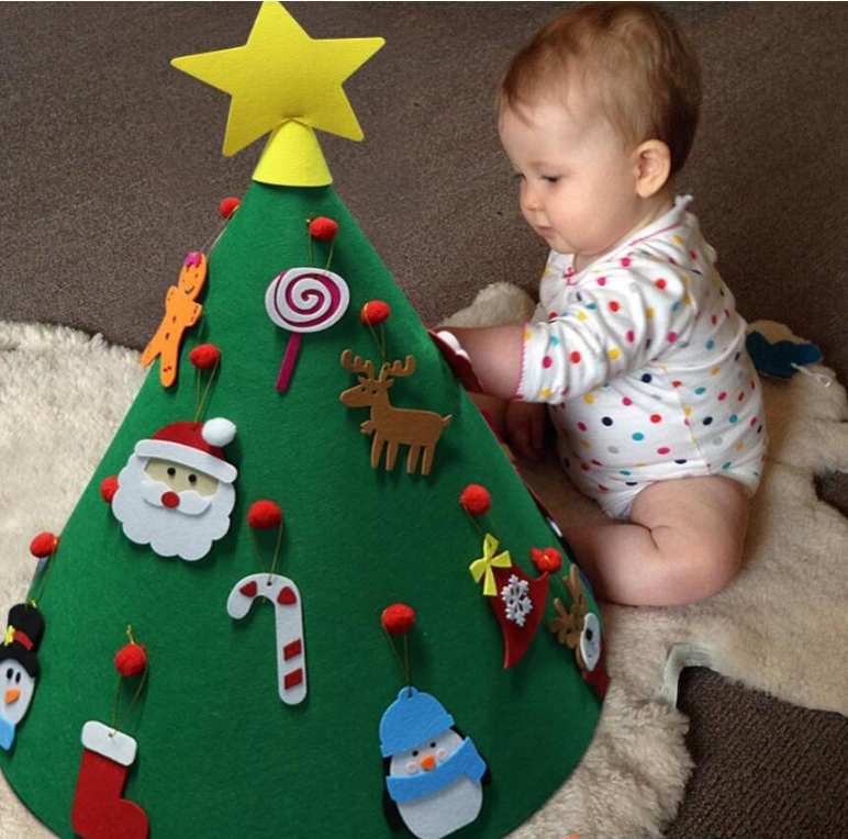Assembled felt Christmas tree with ornaments displayed in cozy holiday setting