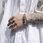 Titanium steel bracelet with Roman numeral and cross patterns close-up