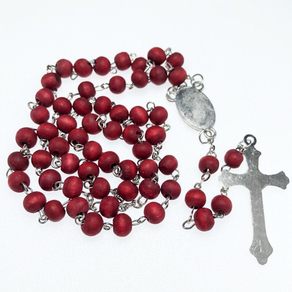 Person wearing wooden Catholic rosary necklace