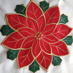 Red and filled embroidered tablecloth displayed on garden table outdoors