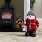 Close-up of resin snowman ornament in cozy red jacket for holiday decorations